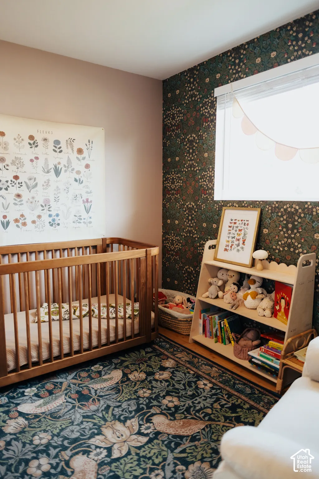 Accent wall featuring botanical-patterned wallpaper and a horizontal window with white horizontal blinds