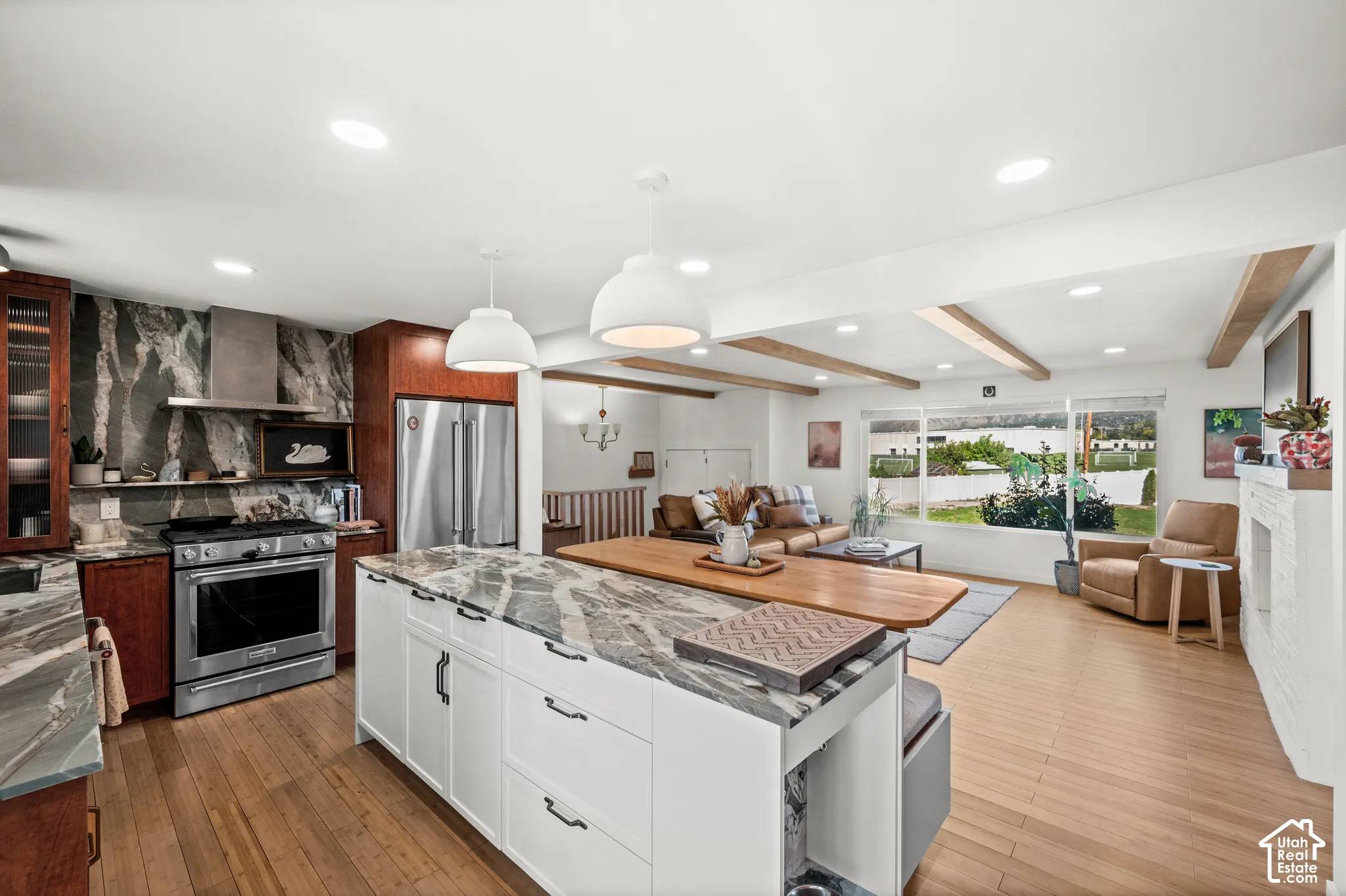 Gourmet kitchen with stone countertops, stainless steel appliances, and a central island