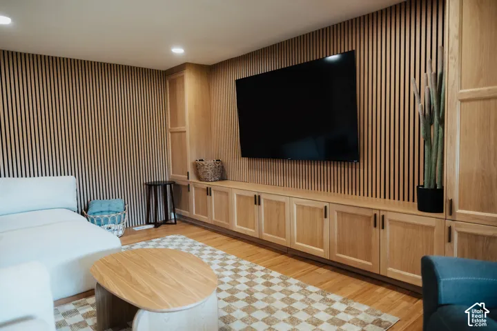 Custom light wood cabinetry with integrated storage and vertical slat wall paneling