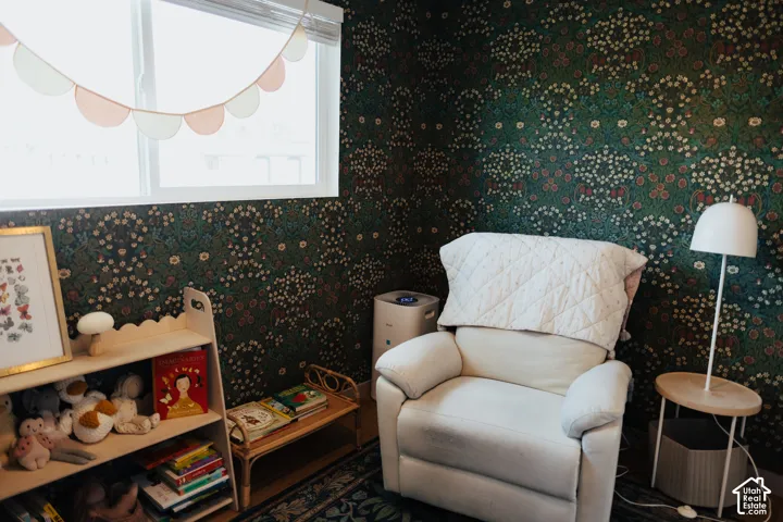 Interior space featuring ornate botanical-print wallpaper and a large horizontal sliding window