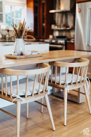 Kitchen island featuring a wood countertop, custom cabinetry, and wood-finish flooring