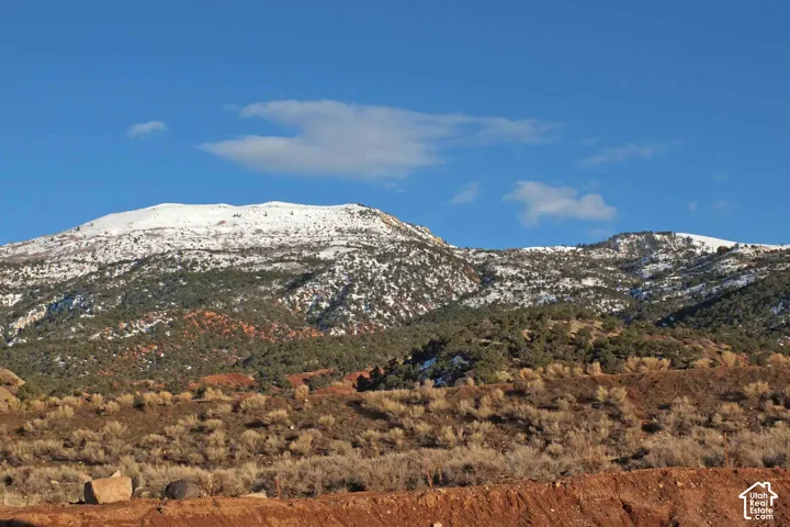 Snow-capped mountains with a clear blue sky background