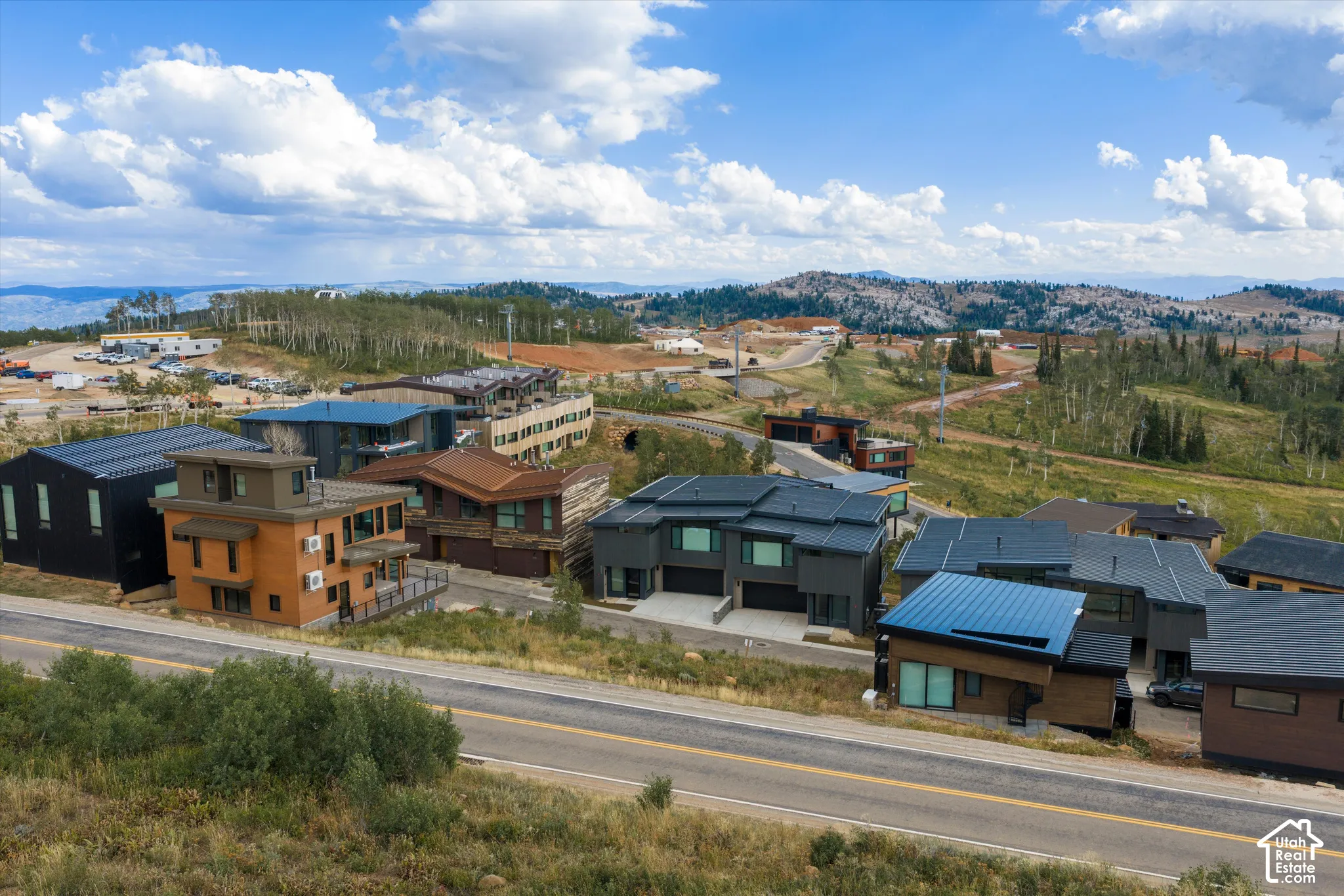Modern architecture with diverse facade materials and expansive mountain terrain