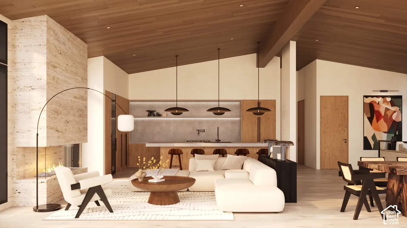Renderings of Vaulted wood-paneled ceilings with exposed beams, a stone-clad fireplace with an integrated hearth, light wood-finish flooring, a kitchen island with a light-toned countertop, and recessed lighting