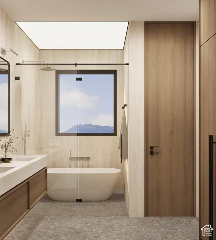 Freestanding soaking tub, wood-finish vanity with dual sinks, glass-enclosed shower, large window, and integrated wood-finish cabinetry