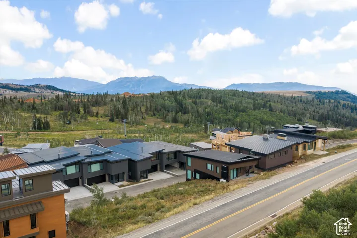 Newly constructed contemporary residences featuring flat and low-pitched roofs, multiple car garages, and distinct exterior finishes