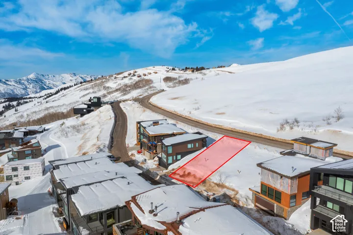 Snow-covered mountain landscape with surrounding properties