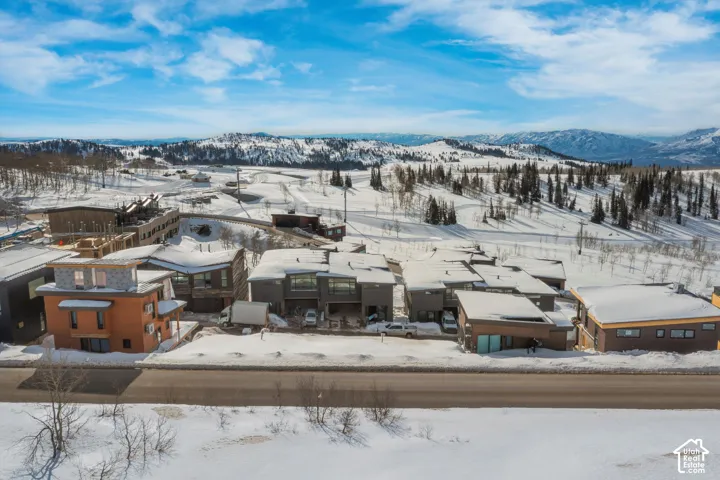 Mountainous terrain surrounds a collection of residential structures