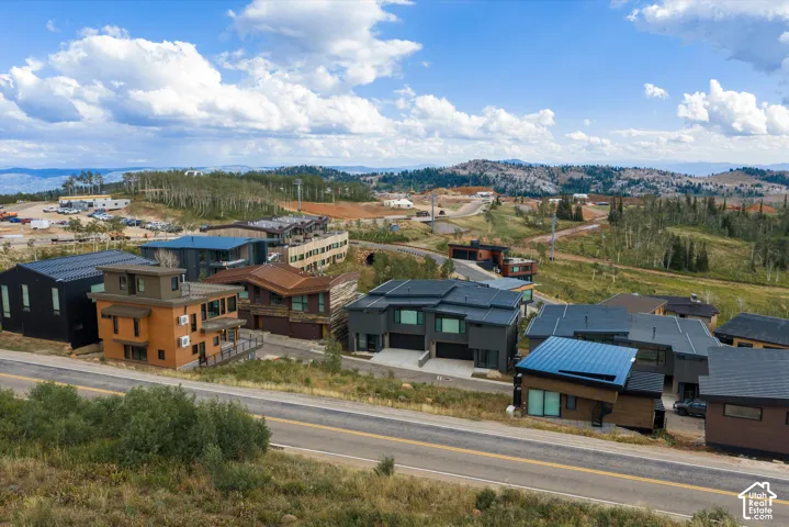 Modern architecture with diverse facade materials and expansive mountain terrain