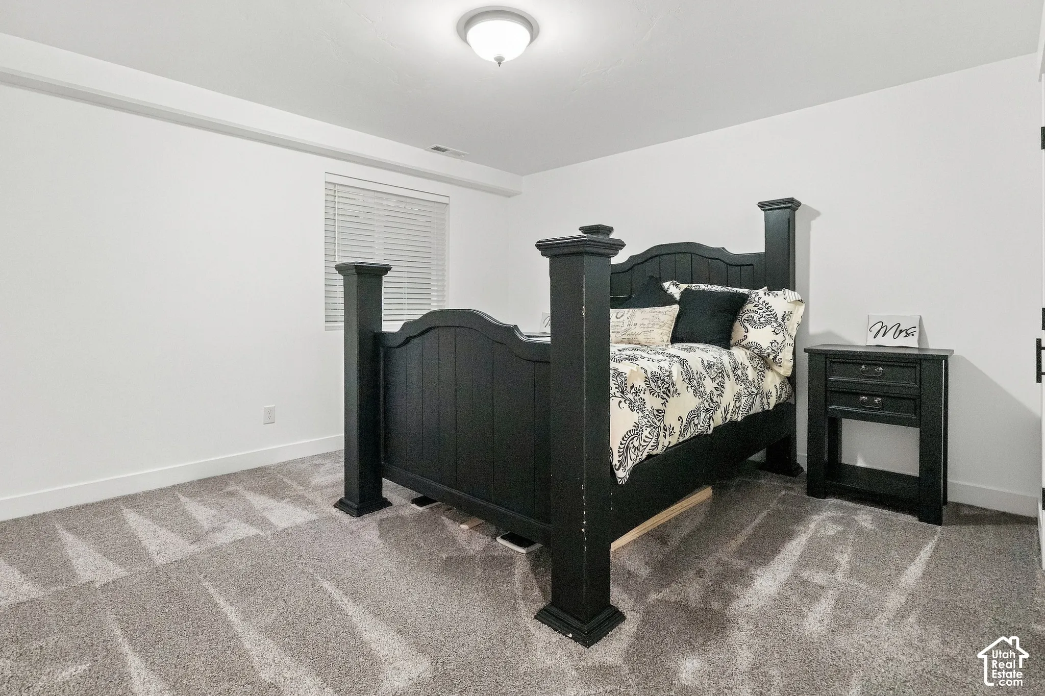 Recessed window with horizontal blinds, neutral wall paint, and gray carpeting