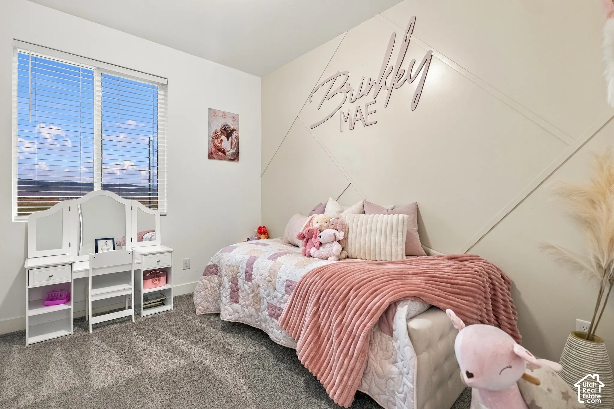 Window with horizontal blinds, carpeted flooring, and an accent wall featuring geometric paneling