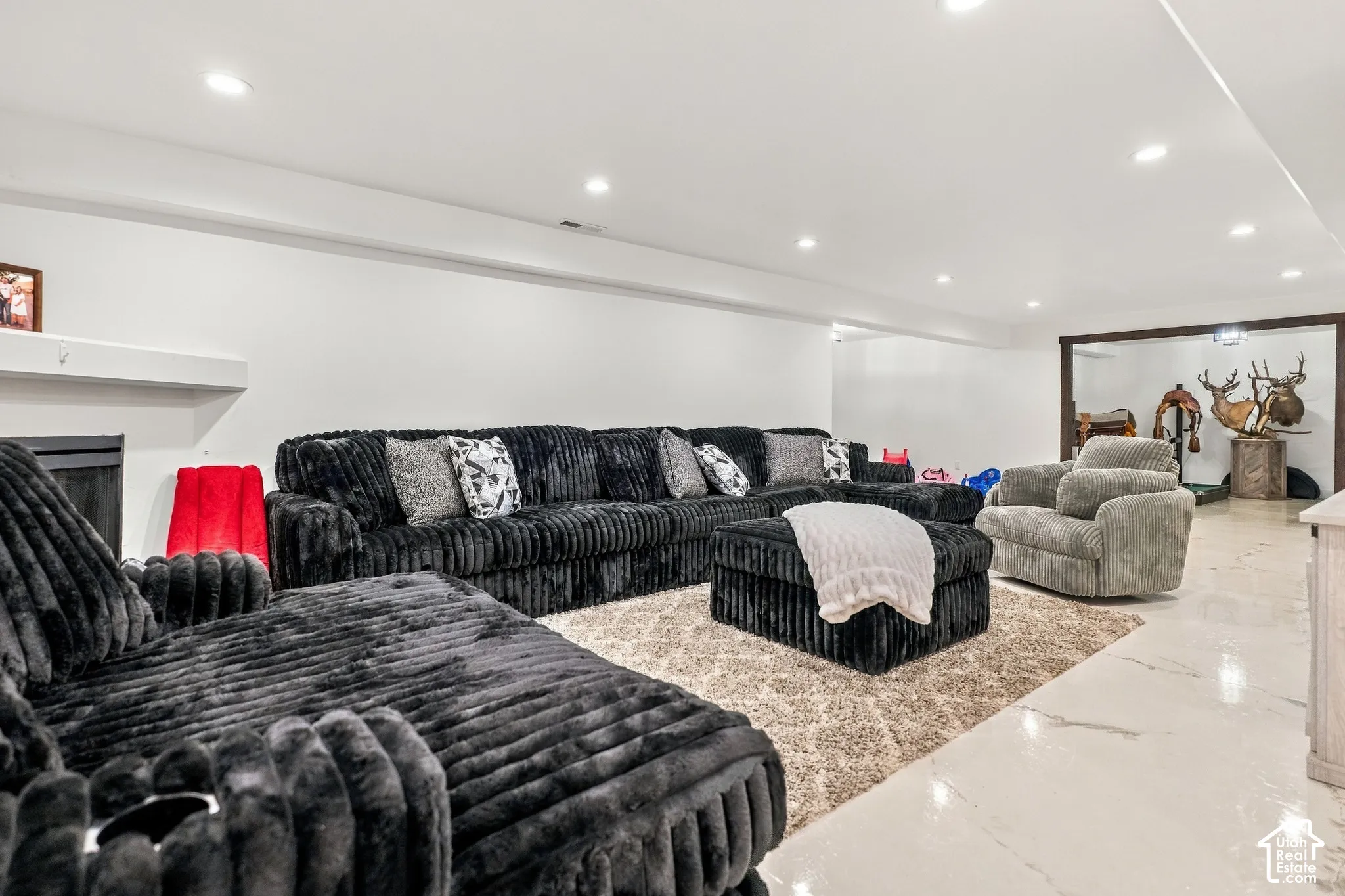 Recessed lighting, fireplace with mantel, white walls, and light-toned flooring
