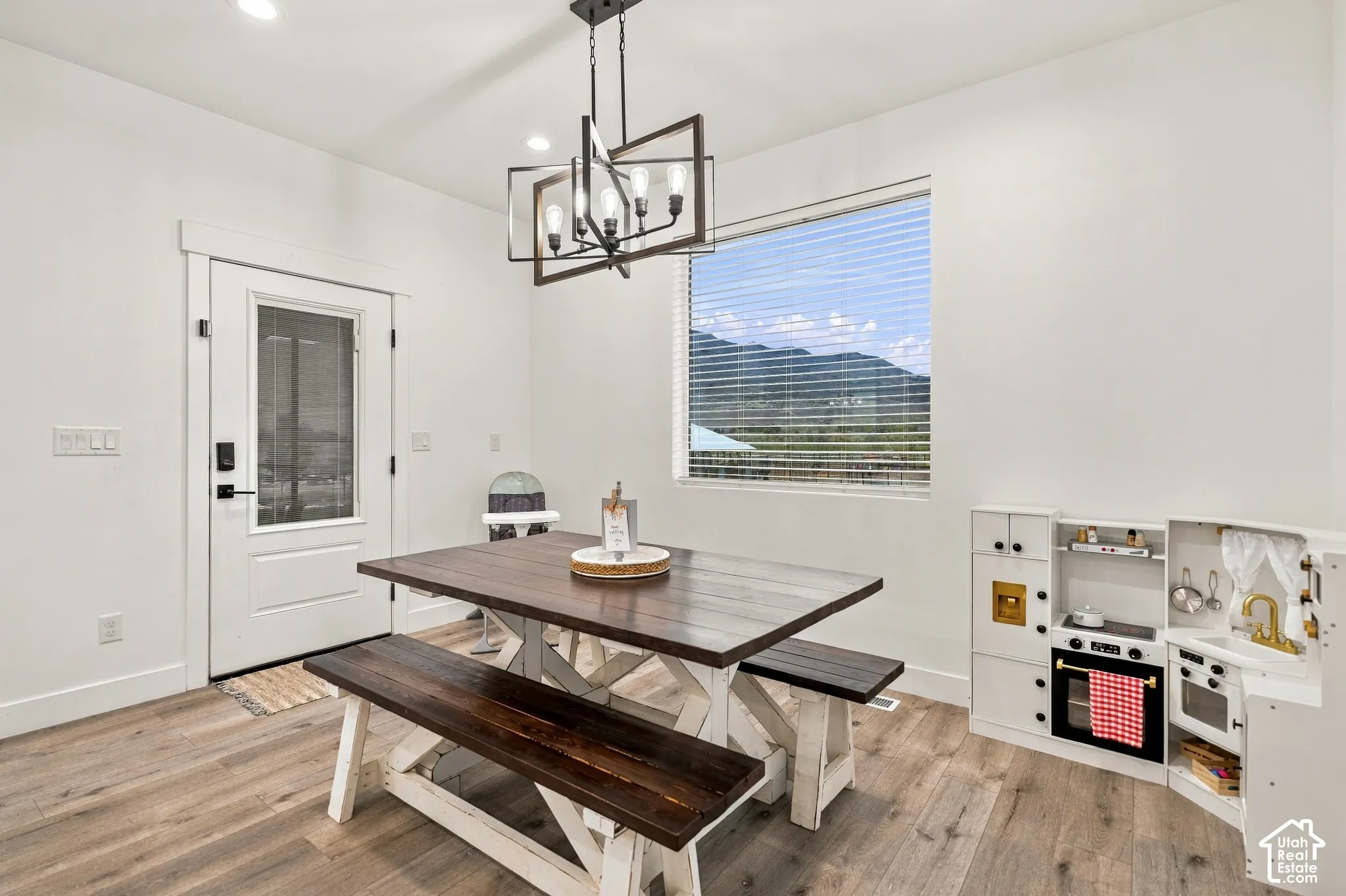 Wood-finish flooring with white walls and recessed lighting