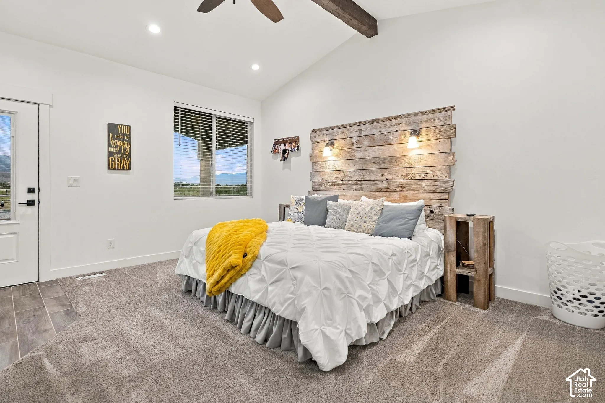 Vaulted ceiling with exposed wood beam, recessed lighting, and a ceiling fan
