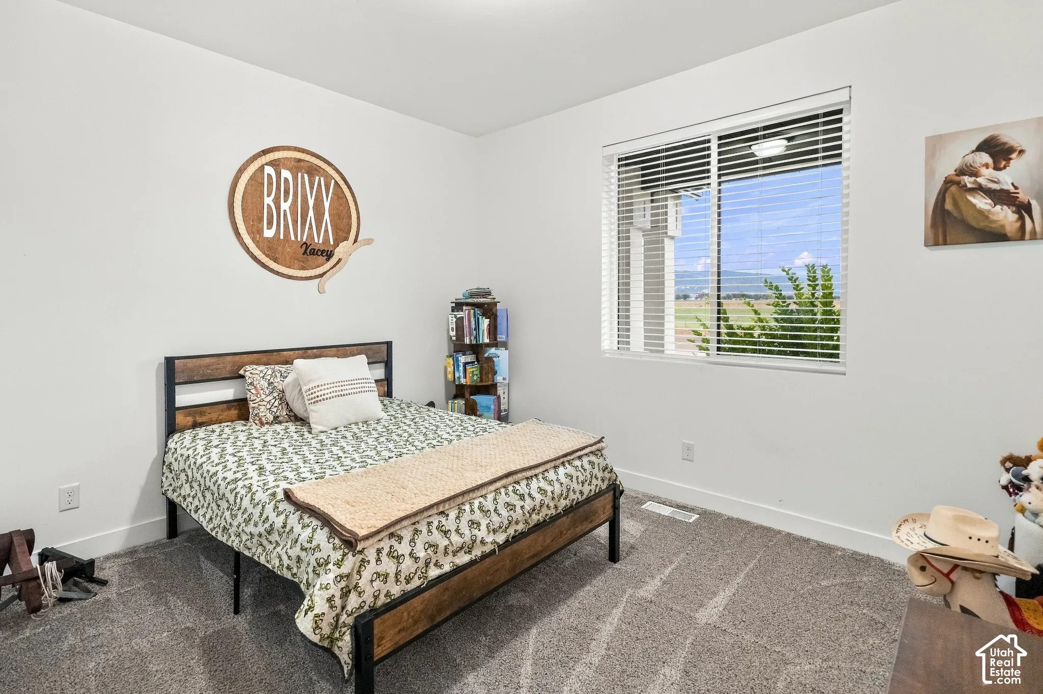 Recessed ceiling lighting illuminates a room featuring carpeted flooring and white painted walls