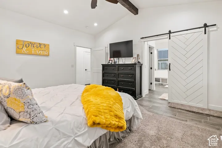 Vaulted ceiling featuring a wood-finish beam and recessed lighting