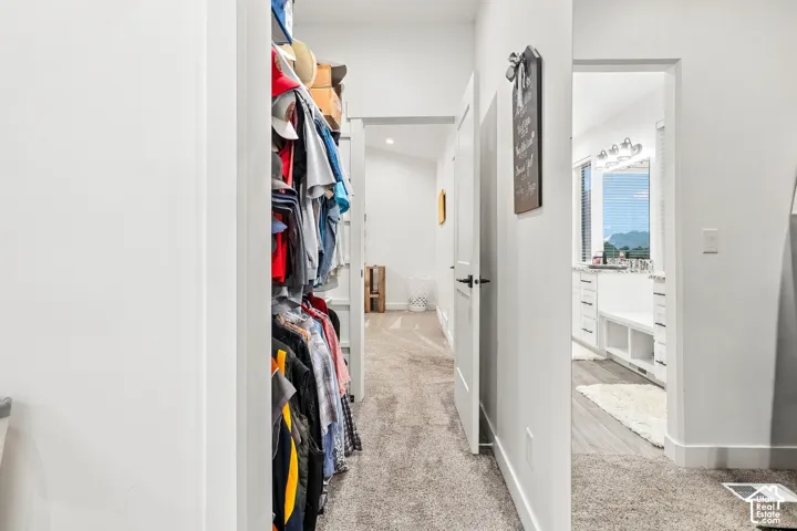 White walls throughout, light gray carpet, and white doors with matte black hardware