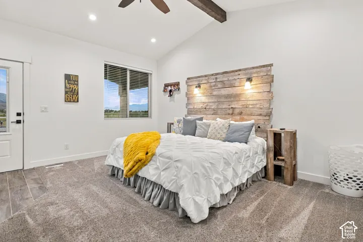 Vaulted ceiling with exposed wood beam, recessed lighting, and a ceiling fan