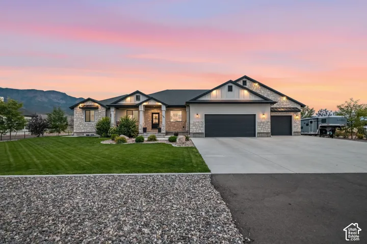 Stone and stucco exterior with dark trim accents