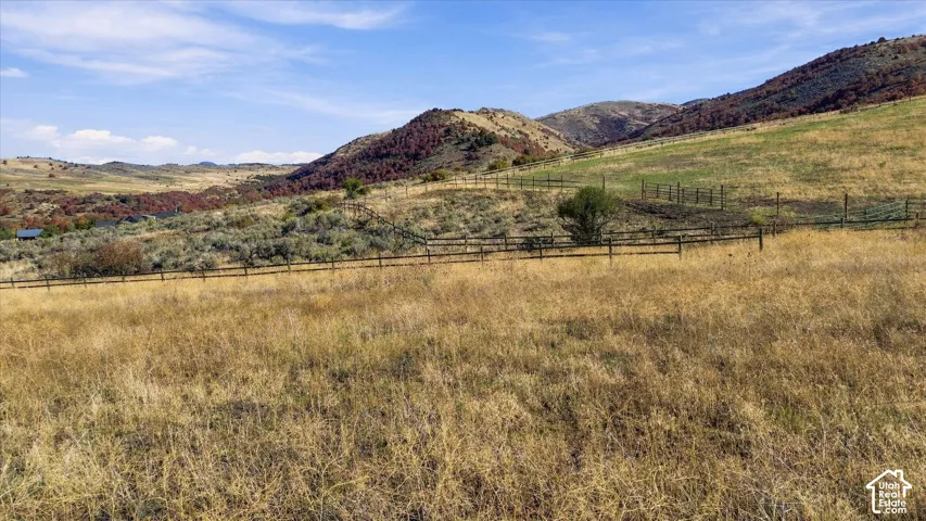 Expansive open land with rolling hills and distant mountains