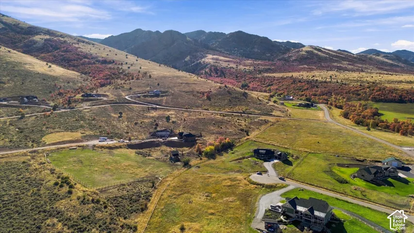 Expansive mountain landscape featuring varied terrain and multiple residential properties