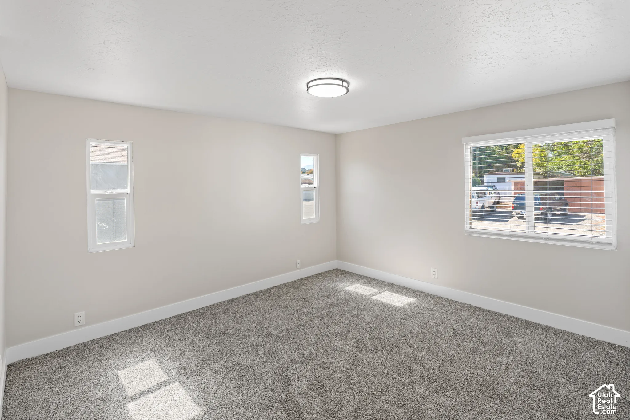 Bright, light-filled bedroom with expansive windows offering natural illumination throughout