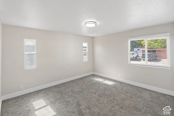 Bright, light-filled bedroom with expansive windows offering natural illumination throughout