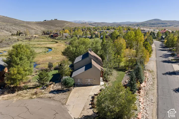 Sloped roofline residence with integrated garage and concrete driveway
