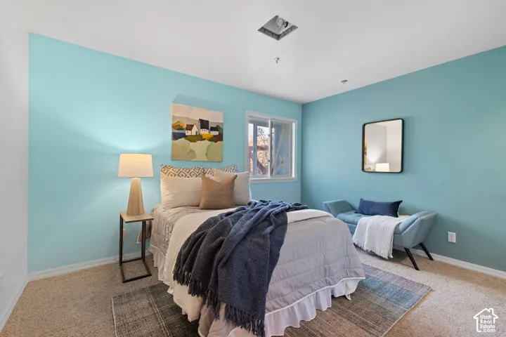 Wall-to-wall carpeting, recessed ceiling fixture, and a window with white trim