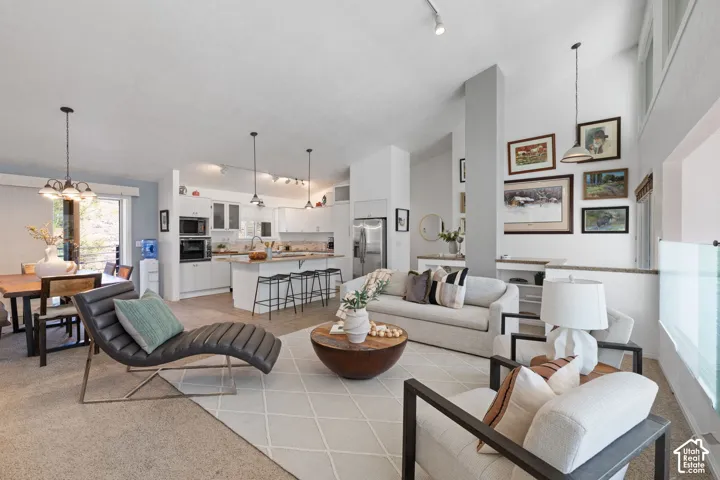 Open-concept layout with vaulted ceilings, recessed lighting, and wood-finish flooring