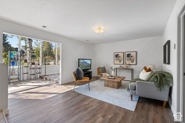 Wood-finish flooring throughout, complemented by a decorative accent wall with diagonal paneling
