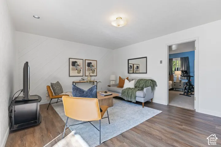 Wood-finish flooring, recessed lighting, and a decorative accent wall