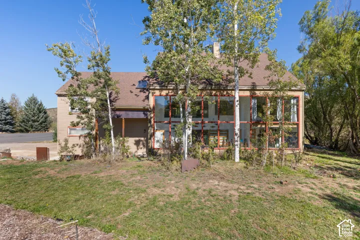 Two-story exterior with a brown roof and light-colored siding