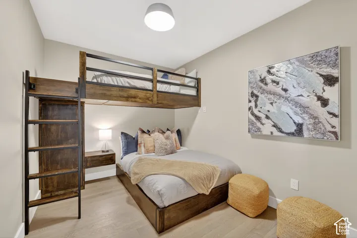 Built-in bunk bed system, wood-finish flooring, recessed ceiling lighting, and neutral wall tones
