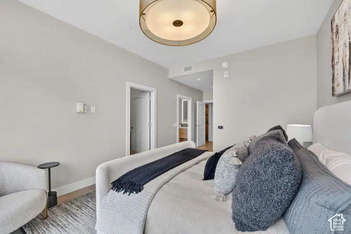Recessed ceiling lighting, wood-finish flooring, and a contemporary ceiling fixture