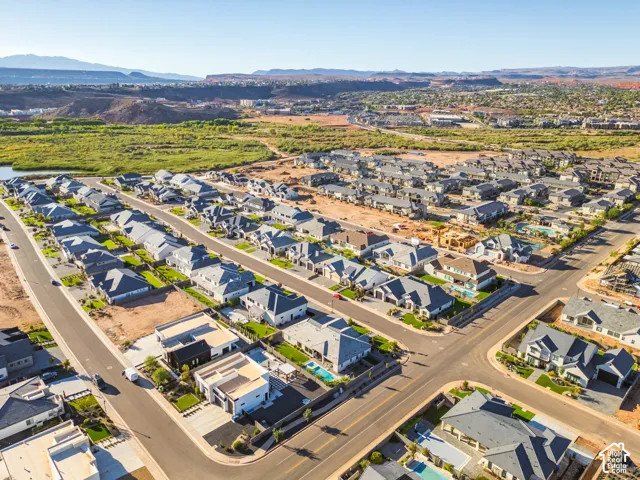 Expansive residential development with diverse architectural styles, hardscaped streets, and clear skies