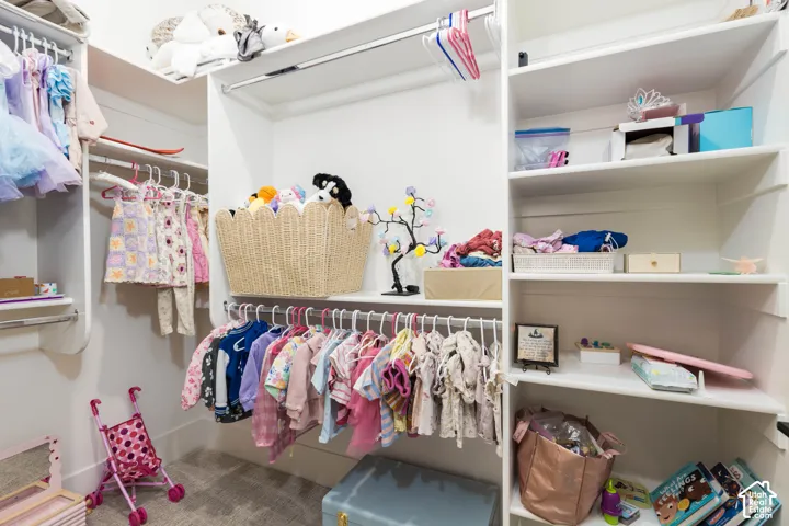 Integrated closet system featuring multiple shelves and hanging rods