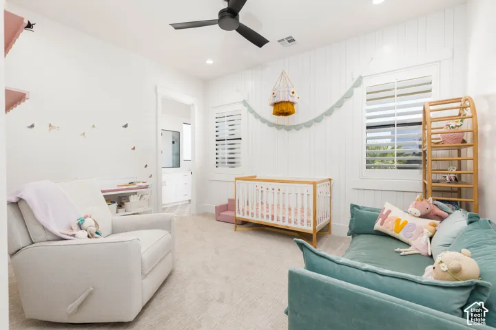 Recessed lighting, ceiling fan, carpet flooring, plantation shutters, and a paneled accent wall
