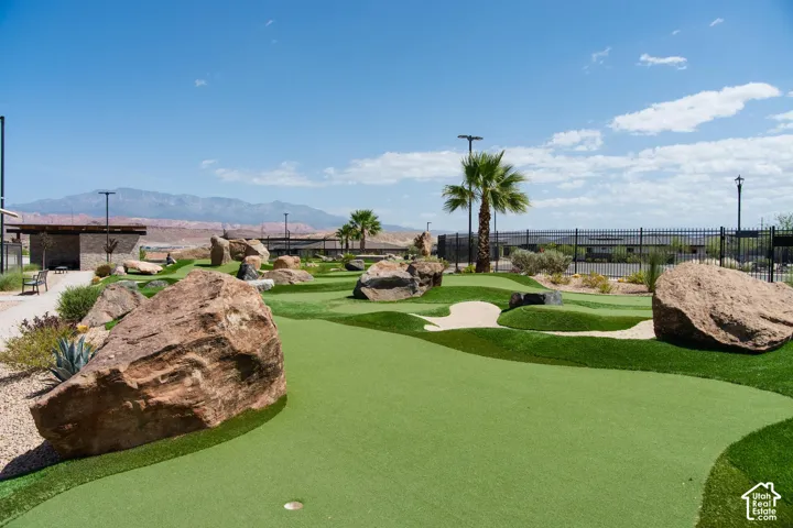 Miniature golf course featuring artificial turf, integrated sand traps, and natural rock accents