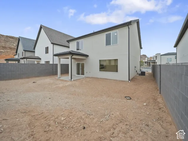 Spacious rear yard with concrete block perimeter fencing