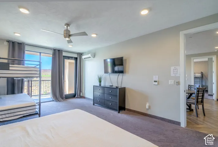 Recessed lighting, ceiling fan, glass door, and wall-mounted air conditioning unit