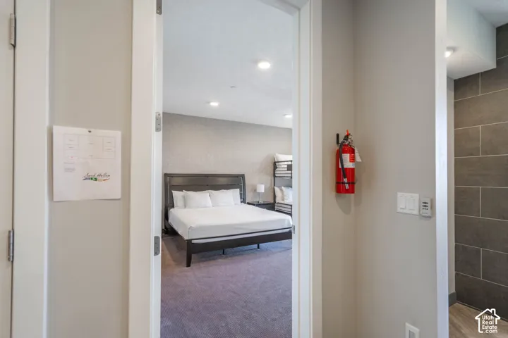 Recessed lighting illuminates the room with textured wall finishes