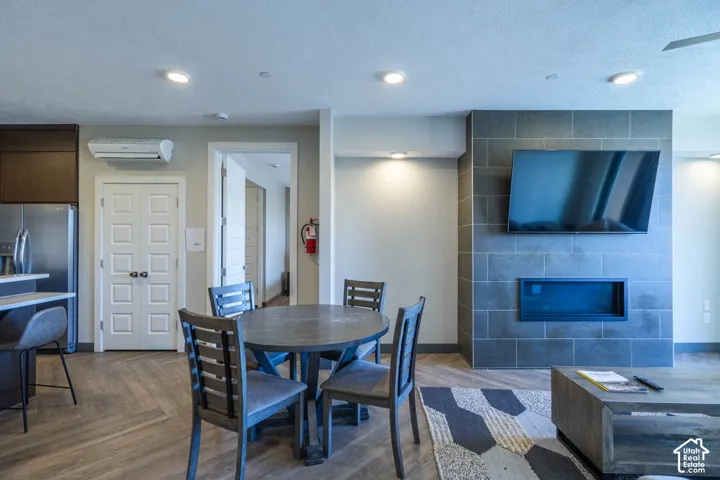 Living area with a tile-clad fireplace feature and recessed lighting