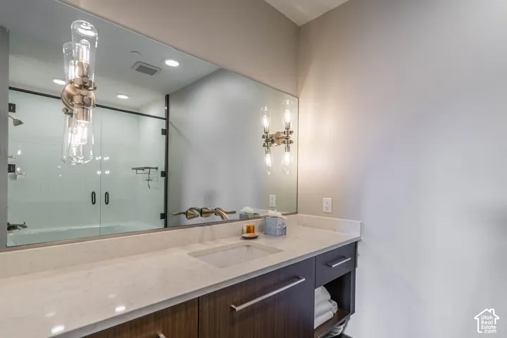 Vanity with a light-toned countertop and an undermount sink