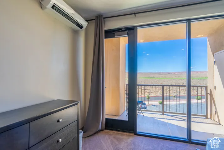 Sliding glass balcony door, built-in air conditioning unit, and private balcony with metal railing