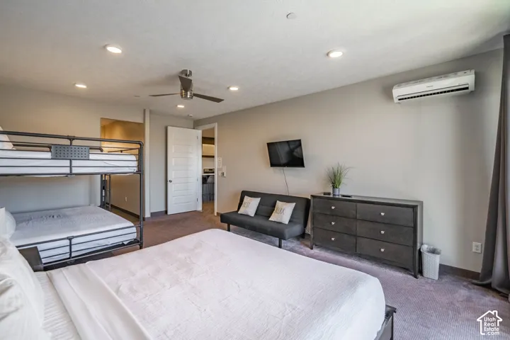 Recessed lighting, ceiling fan, wall-mounted television, and a mini-split air conditioning unit