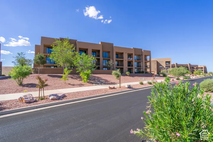 Multi-story building featuring a stucco exterior and multiple private balconies