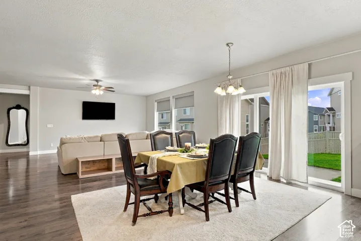 Dining area, ceiling fan with integrated lighting, recessed lighting, chandelier with four light fixtures, and sliding glass doors