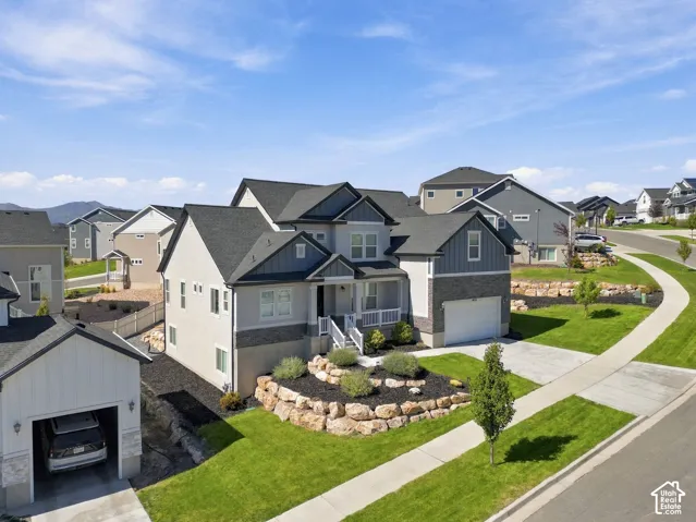 Contemporary multi-level residence featuring a covered entry, attached garage, and tiered landscaping