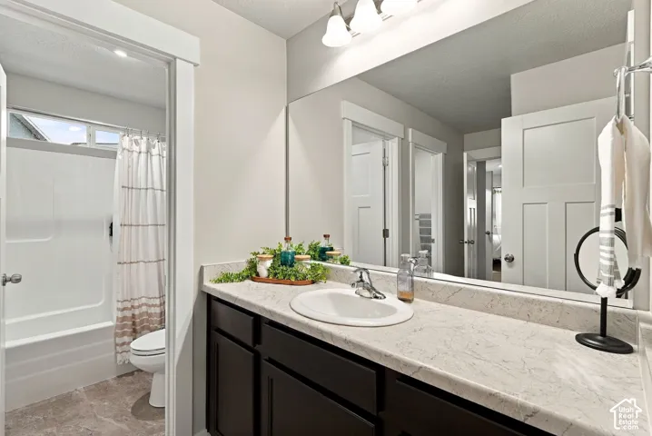 Dark wood-finish cabinetry with a light-toned countertop, an integrated sink, and an extended mirror